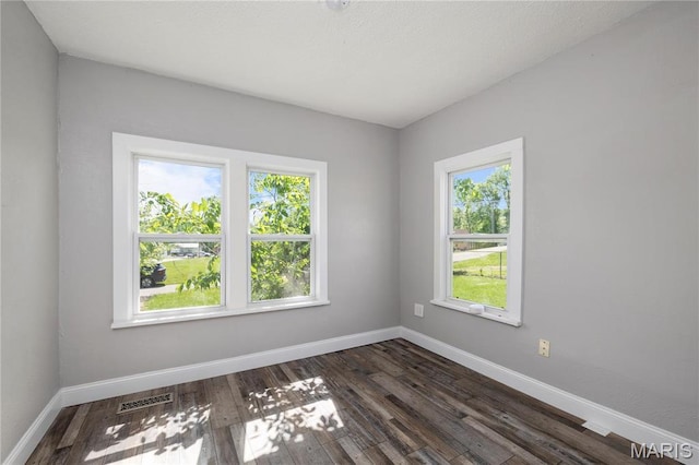 400 Main St, Waynesville, MO 65583 - unfurnished room with dark wood-style floors and baseboards