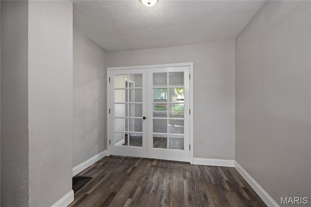 400 Main St, Waynesville, MO 65583 - empty room with french doors, wood finished floors, baseboards, and a textured ceiling