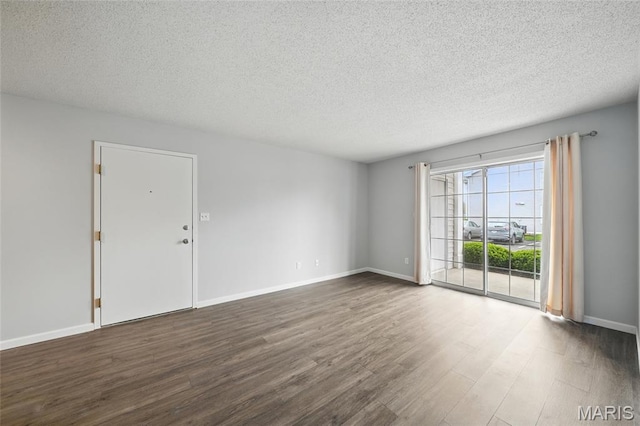 9 Berview Cir Unit H, Saint Louis, MO 63129 - empty room with dark wood-style flooring, a textured ceiling, and baseboards