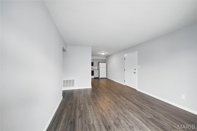 9 Berview Cir Unit H, Saint Louis, MO 63129 - unfurnished living room featuring dark wood-style flooring and baseboards