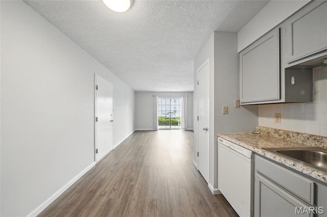 9 Berview Cir Unit H, Saint Louis, MO 63129 - kitchen featuring white dishwasher, gray cabinets, a textured ceiling, dark wood finished floors, and decorative backsplash