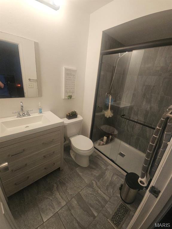 full bath with a shower stall, toilet, and vanity