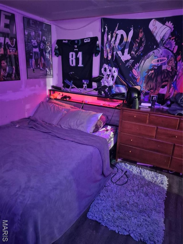 bedroom featuring wood finished floors