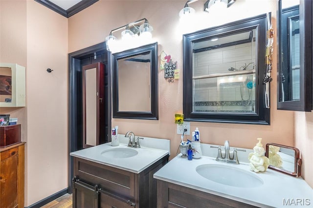 732 N Main St, Poplar Bluff, MO 63901 - bathroom with two vanities, ornamental molding, and wood finished floors