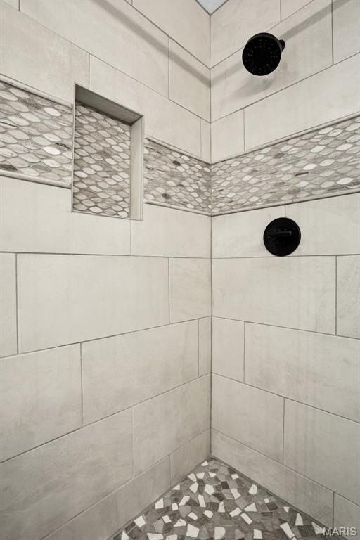bathroom with a tile shower