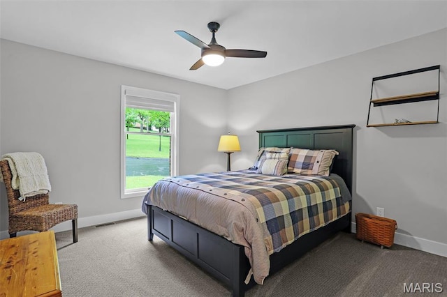 bedroom with light carpet, baseboards, and a ceiling fan