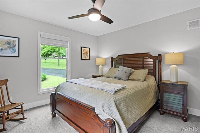 carpeted bedroom featuring baseboards and ceiling fan