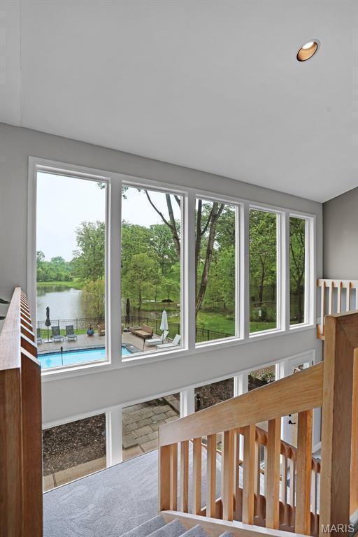 unfurnished sunroom featuring a water view