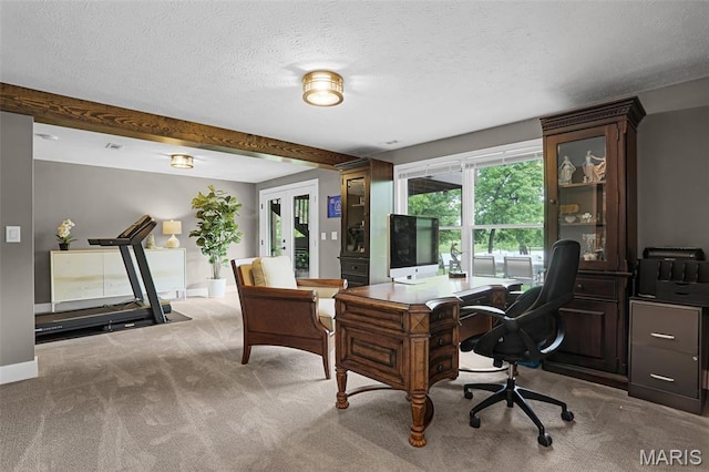 office space featuring carpet, baseboards, beamed ceiling, and a textured ceiling