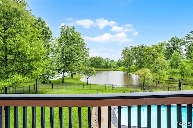balcony featuring a water view and view of scattered trees