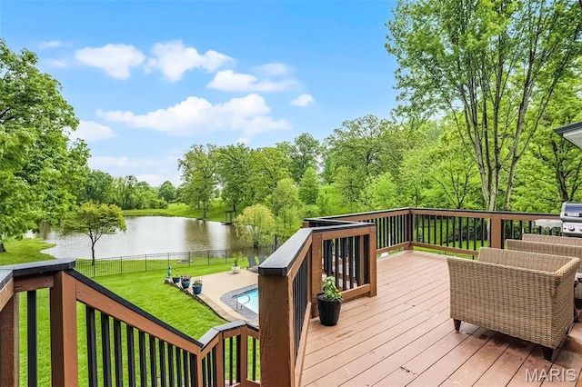 deck featuring a water view and view of wooded area