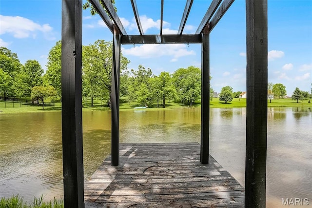 dock featuring a water view and view of wooded area