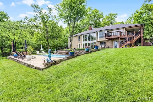 back of house with a ceiling fan, stairs, a wooden deck, a chimney, and a patio area