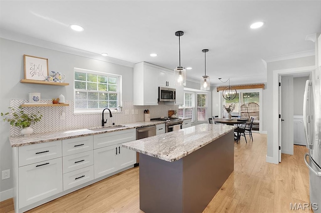 66 Walnutshade Ct, Saint Peters, MO 63376 - kitchen with stainless steel appliances, ornamental molding, white cabinets, decorative backsplash, and recessed lighting