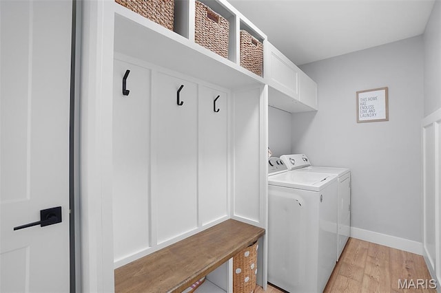 66 Walnutshade Ct, Saint Peters, MO 63376 - washroom with separate washer and dryer, light wood-style flooring, and cabinet space