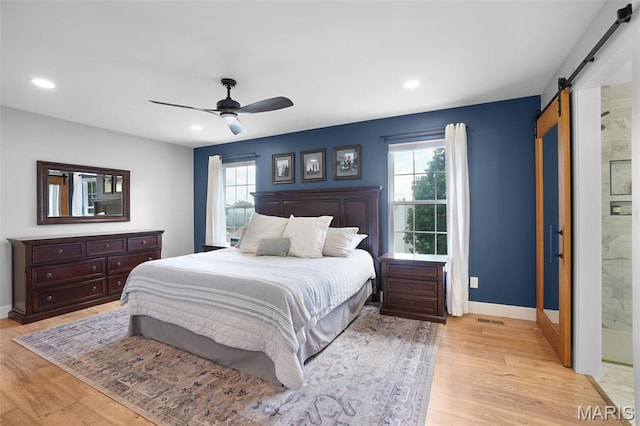 66 Walnutshade Ct, Saint Peters, MO 63376 - bedroom featuring a barn door, multiple windows, light wood-style floors, recessed lighting, and ceiling fan