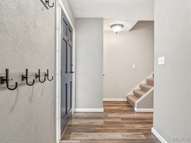605 S Ridge Ave, Steeleville, IL 62288 - hall with wood finished floors, baseboards, stairway, and a textured wall