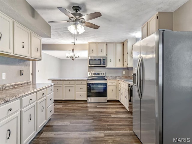605 S Ridge Ave, Steeleville, IL 62288 - kitchen featuring appliances with stainless steel finishes, a ceiling fan, dark wood finished floors, a sink, and a chandelier