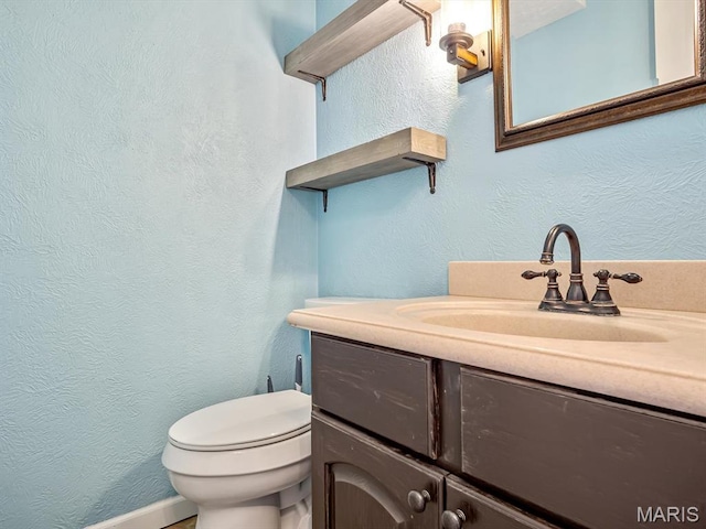 605 S Ridge Ave, Steeleville, IL 62288 - half bathroom featuring vanity, toilet, and a textured wall