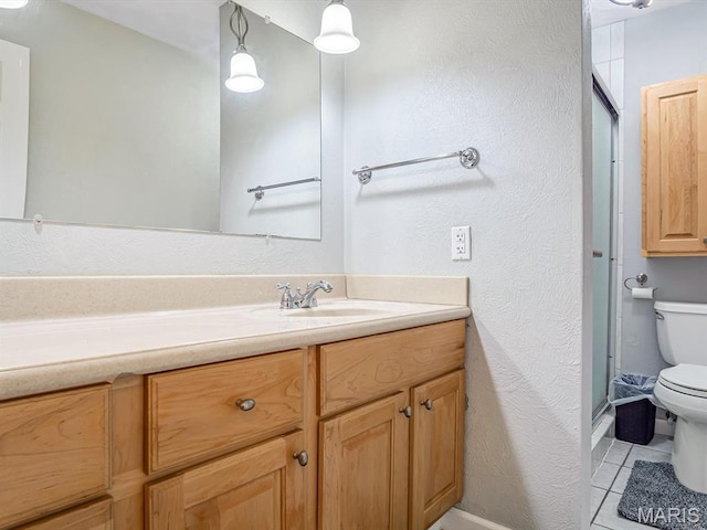 605 S Ridge Ave, Steeleville, IL 62288 - full bath with toilet, an enclosed shower, vanity, tile patterned flooring, and baseboards