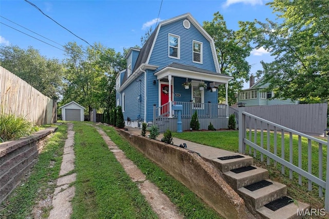 7211 Kensington Ave, Maplewood, MO 63143 - dutch colonial featuring a porch, driveway, a garage, an outbuilding, and a gambrel roof