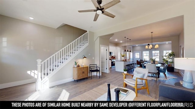 3229 Portis Ave, Saint Louis, MO 63116 - living room featuring stairs, light wood finished floors, a ceiling fan, baseboards, and recessed lighting