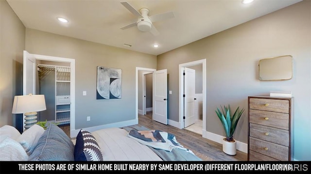 3229 Portis Ave, Saint Louis, MO 63116 - bedroom featuring baseboards, wood finished floors, a spacious closet, recessed lighting, and connected bathroom