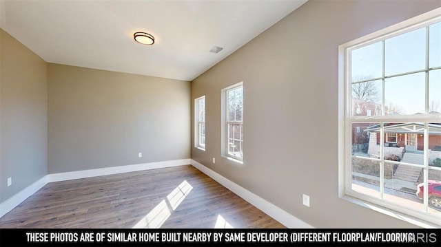 3229 Portis Ave, Saint Louis, MO 63116 - empty room with wood finished floors and baseboards