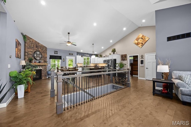 409 Briar Creek Rd, Troy, IL 62294 - kitchen featuring open floor plan, white cabinetry, a ceiling fan, wood finished floors, and high vaulted ceiling