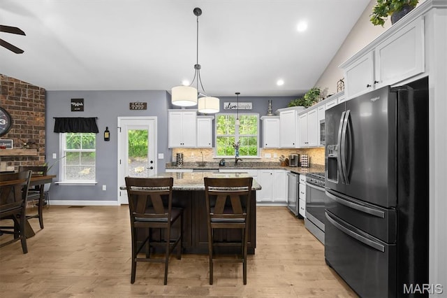 409 Briar Creek Rd, Troy, IL 62294 - kitchen with stainless steel appliances, a ceiling fan, white cabinetry, tasteful backsplash, and a kitchen island