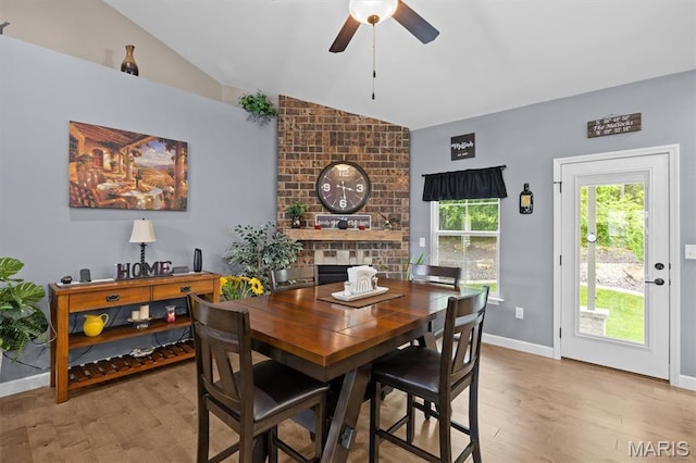 409 Briar Creek Rd, Troy, IL 62294 - dining area featuring vaulted ceiling, a ceiling fan, light wood-type flooring, baseboards, and a fireplace