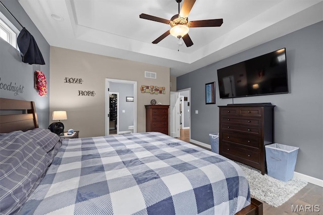 409 Briar Creek Rd, Troy, IL 62294 - bedroom with a raised ceiling, baseboards, and a ceiling fan
