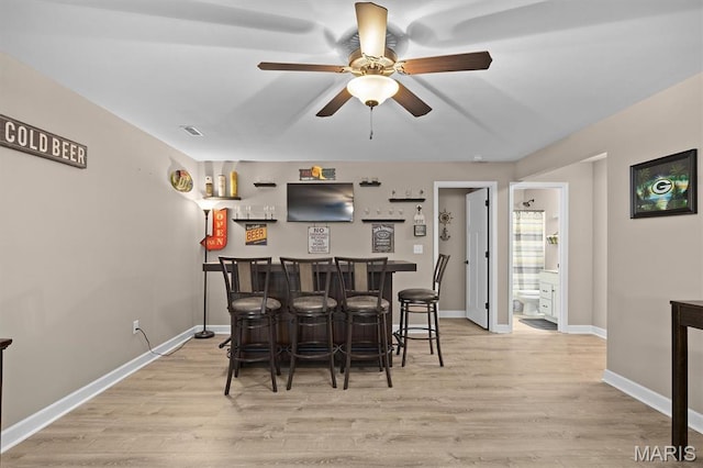 409 Briar Creek Rd, Troy, IL 62294 - dining room featuring a dry bar, light wood finished floors, a ceiling fan, and baseboards