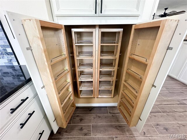 906 E Pace St, Salem, MO 65560 - detailed view of wood finished floors, a ceiling fan, and white cabinetry