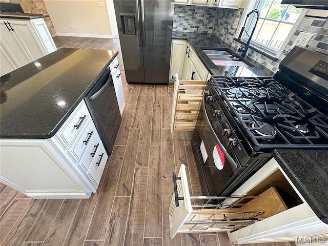 906 E Pace St, Salem, MO 65560 - kitchen featuring stainless steel appliances, wood finished floors, decorative backsplash, baseboards, and white cabinets