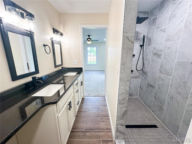 906 E Pace St, Salem, MO 65560 - bathroom featuring ceiling fan, walk in shower, double vanity, wood finished floors, and baseboards