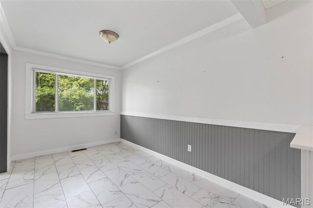 1095 Rogers Ln, Florissant, MO 63033 - empty room featuring marble finish flooring, a wainscoted wall, and crown molding