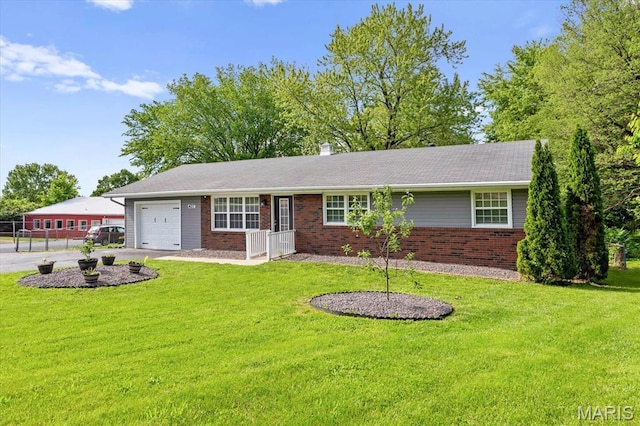 ranch-style home featuring an attached garage, brick siding, a front lawn, and driveway