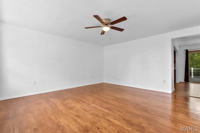 empty room featuring light wood-type flooring and ceiling fan