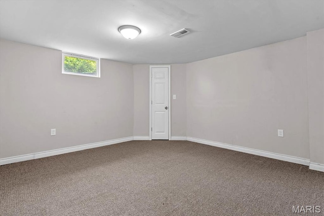 empty room featuring carpet and baseboards