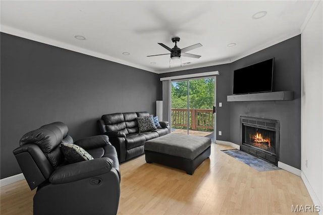 34 Sugar Grove Ct, Saint Peters, MO 63376 - living room featuring ceiling fan, a fireplace with flush hearth, ornamental molding, light wood-type flooring, and baseboards