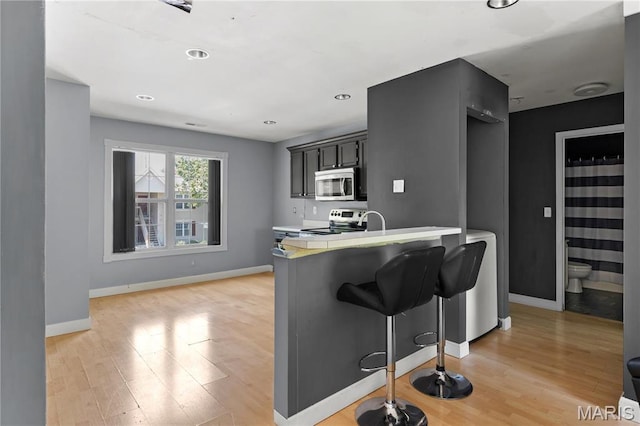 34 Sugar Grove Ct, Saint Peters, MO 63376 - kitchen with appliances with stainless steel finishes, light countertops, light wood-type flooring, and baseboards