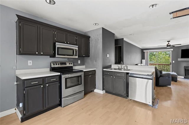 34 Sugar Grove Ct, Saint Peters, MO 63376 - kitchen with stainless steel appliances, a peninsula, open floor plan, light wood-style flooring, and ceiling fan