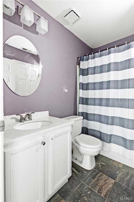 34 Sugar Grove Ct, Saint Peters, MO 63376 - full bathroom with vanity, toilet, and a shower with shower curtain
