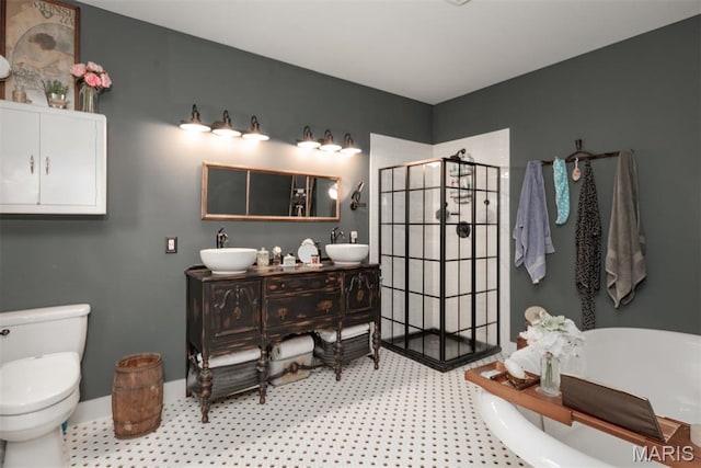 7877 Sylvan Pl, Dittmer, MO 63023 - bathroom featuring a freestanding tub, a walk in shower, toilet, and double vanity