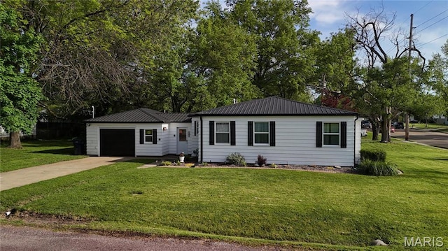 view of front of property featuring concrete driveway, a garage, a front yard, and metal roof