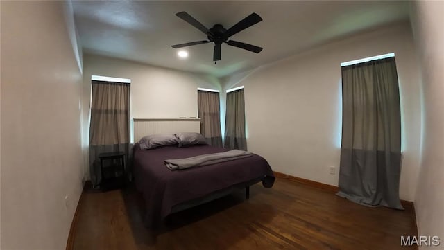 bedroom with wood finished floors, baseboards, and a ceiling fan