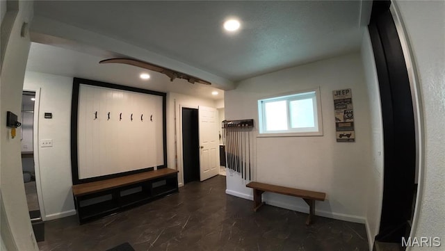 hallway featuring baseboards and recessed lighting