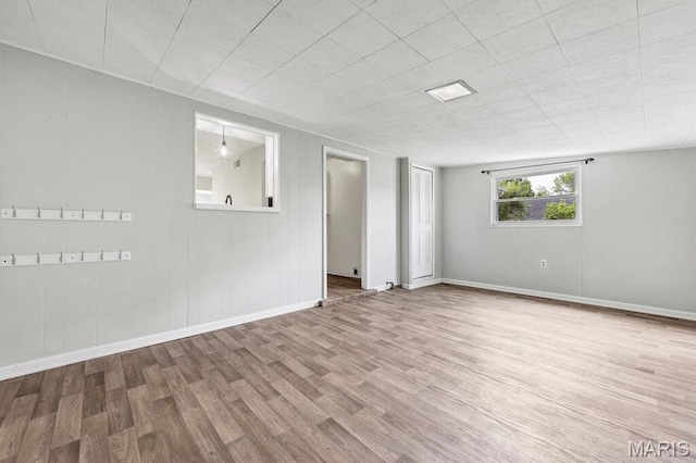 spare room featuring wood finished floors and baseboards