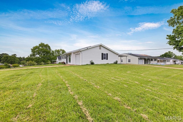 view of property exterior with a lawn and a garage